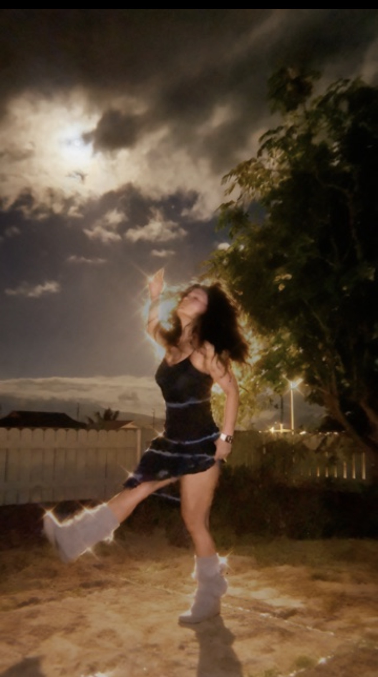 Misty dancing outdoors at night under dramatic light, cinematic ShaktiRize energy